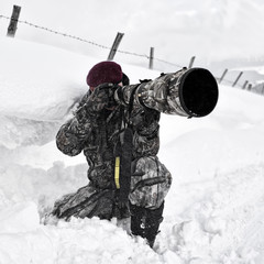 Wall Mural - professional photographer outdoor in winter on harsh weather