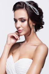 Wall Mural - Portrait of beautiful young brunette woman bride in white Weddin