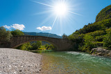Roman Bridge and Sarca River - Italy / Ancient roman bridge over the Sarca river in the Sarca Valley, Ceniga, Dro, Trentino Alto Adige, Italy, Europe