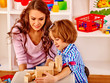 © Gennadiy Poznyakov - Little girl and her mother play by toy bricks at home.