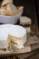 Wall Mural - Creamy Camembert on wooden background