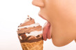 Young girl licking an ice cream.