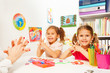 © Sergey Novikov - Two girls doing finger exercises as her teacher