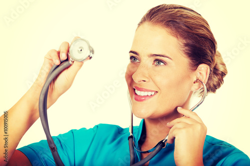 Naklejka - mata magnetyczna na lodówkę Young female doctor or nurse with stethocope