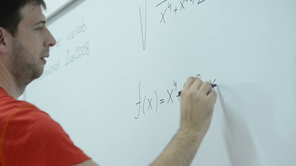 student working on math task on white board and finding solution at modern classroom,  school and education concept
