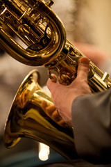 Wall Mural -  Detail baritone saxophone in the hands of a musician in the orchestra