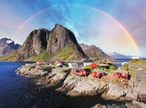Fototapeta  - Norwegian fishing village huts with rainbow, Reine, Lofoten Isla