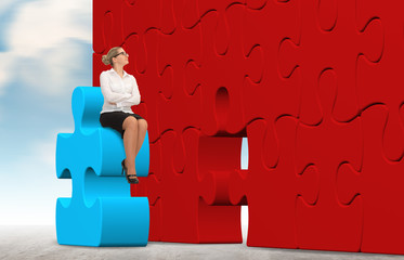 Business woman building a puzzle on a sky background
