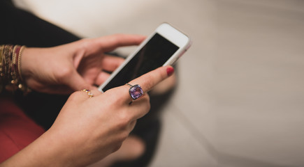 Hands of a woman texting on her mobile phone