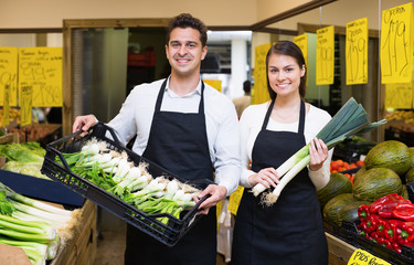 Wall Mural - Smiling woman and man selling fresh fruit