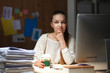 © shefkate - Young woman working in office, sitting at desk