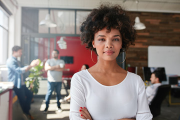 woman standing in busy creative office
