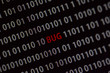 © Jne Valokuvaus - 'Bug' word in the middle of the computer screen surrounded by numbers zero and one. Image is taken in a small angle.