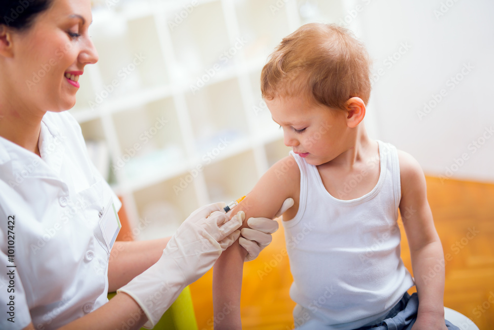 Pediatrician makes vaccination to small boy - obrazy, fototapety, plakaty 