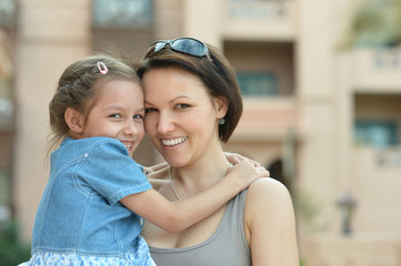 Wall Mural - mother with daughter near hotel