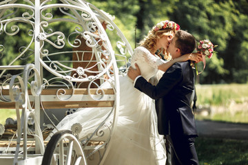 Canvas Print - Romantic fairy-tale wedding couple bride and groom kissing in ma