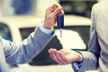 Sticker - close up of male hands with car key in auto salon