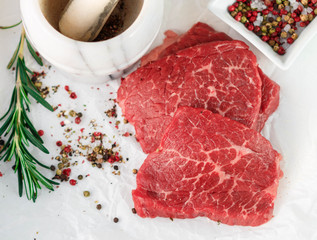 Raw fresh steaks from the marble beef, rosemary and spices. Top view