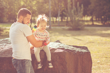 Wall Mural - Girl with dad sitting in the park