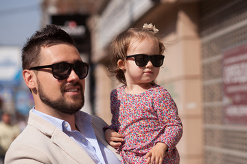 Wall Mural - Young father walking with tiny daughter