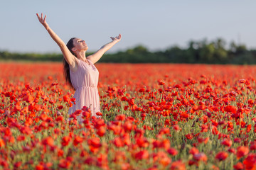 Wall Mural - Girl at blooming poppy field