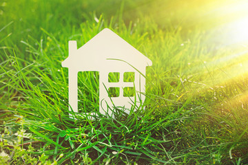 Sticker - Small model of house over green grass background