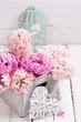 Pink hyacinths in box  and decorative heart on white wooden back