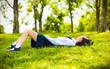 © 9'63 Creation - Asian Thai teenage female schoolgirl student in high school uniform with leather shoes lie down sleeping or relaxing on the green grass field wilderness park with summer natural sunlight