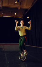 Boy Juggling And Riding Unicycle