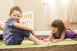 © Mike Kemp/Blend Images - Caucasian girl painting brother's toes