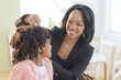 © JGI/Tom Grill/Blend Images - African American mother fixing daughter's hair