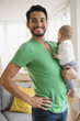 © JGI/Jamie Grill/Blend Images - Father holding baby in living room