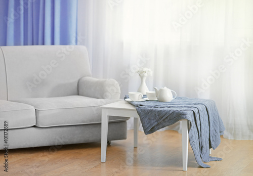 Sofa And Little Table With Home Decor In The Room In Front Of The