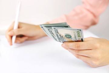 Sticker - Hand holding dollar banknotes on white background