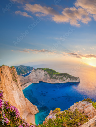 Tapeta ścienna na wymiar Navagio beach with shipwreck against sunset on Zakynthos island in Greece