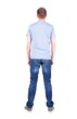 © ghoststone - Back view of young man in t-shirt and jeans  looking.