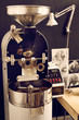 Modern coffee bean roasting machine with shiny metal parts