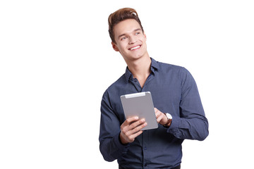 Wall Mural - Smiling young man using tablet computer against a white background