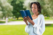 © fotofabrika - Close-up portrait of a young african woman with a book