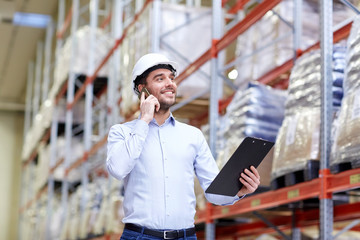 Wall Mural - man with clipboard and smartphone at warehouse