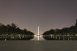 Night time view of the Lincoln Memorial Reflecting Pool & Washington's grand tree-lined boulevard towards the Washington Monument, National Mall & Memorial Parks, Washington DC
