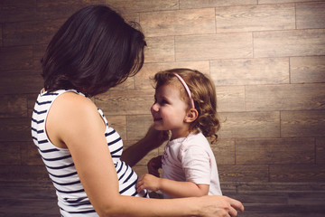 Wall Mural - Girl Looking at Pregnant Mother