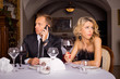 Annoyed woman being angry about  her date talking on the phone 