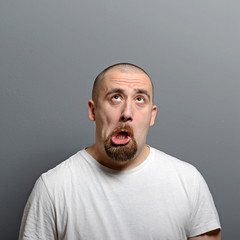 Wall Mural - Portrait of a man making funny face against gray background