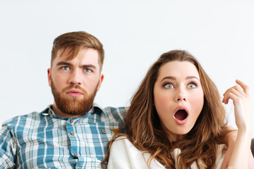 Sticker - Shocked couple looking TV at home