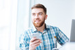 © Drobot Dean - Happy man using smartphone and looking away