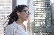 Young latin professional woman with glasses in the city