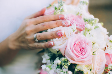 Beautiful wedding bouquet in hands of the bride