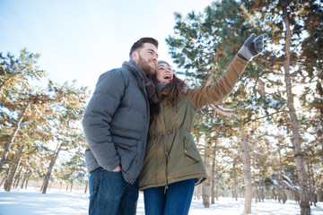 Poster - Couple looking on something in winter park