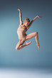 © master1305 - Young beautiful modern style dancer jumping on a studio background